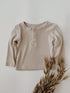 Infant ribbed shirt in a taupe color with three Henley style buttons.