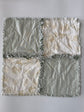 Quilt with a patchwork design featuring gray and beige colors on a white background
