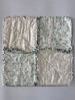 Quilt with geometric pattern on a plain background