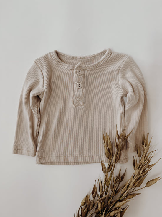 Infant ribbed shirt in a taupe color with three Henley style buttons.